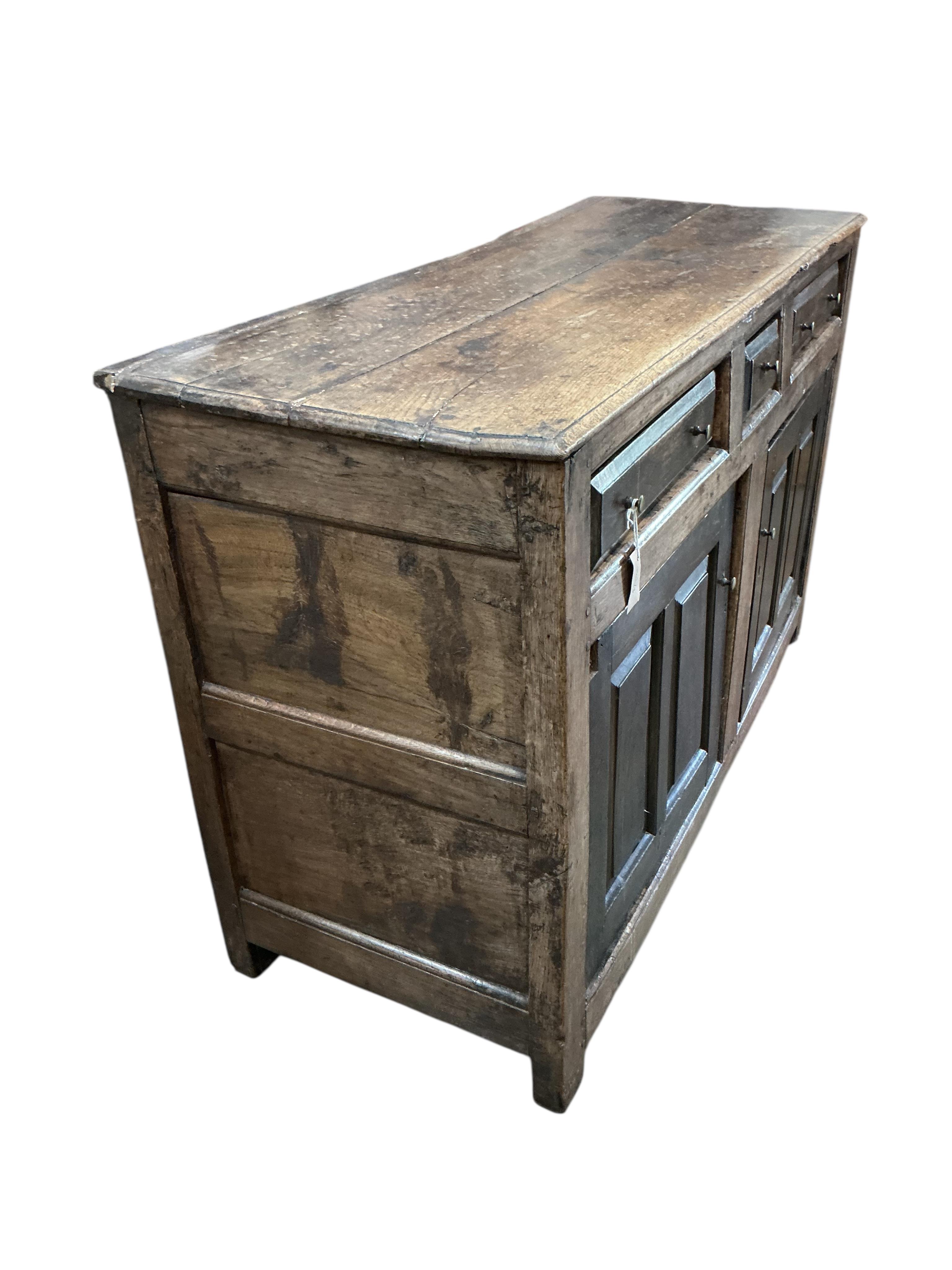 A mid 18th century North Wales oak enclosed dresser base, width 134cm, depth 52cm, height 85cm